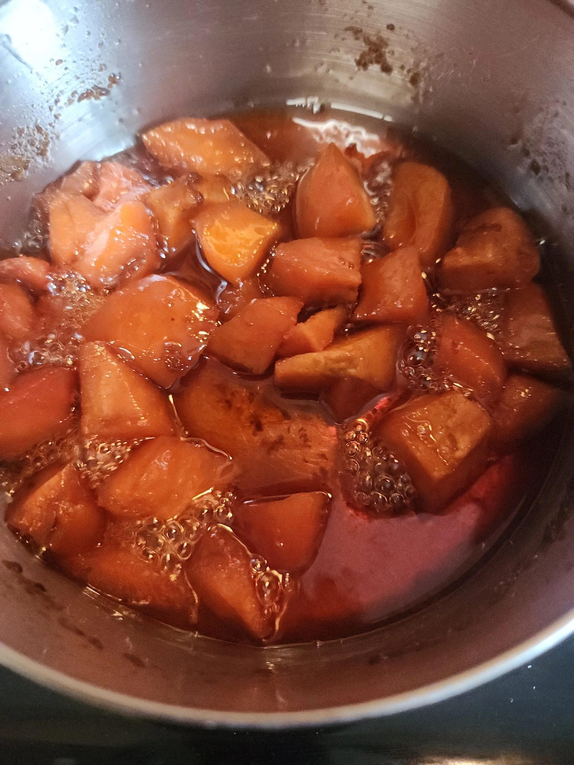 Quinces cooking in pot with spices