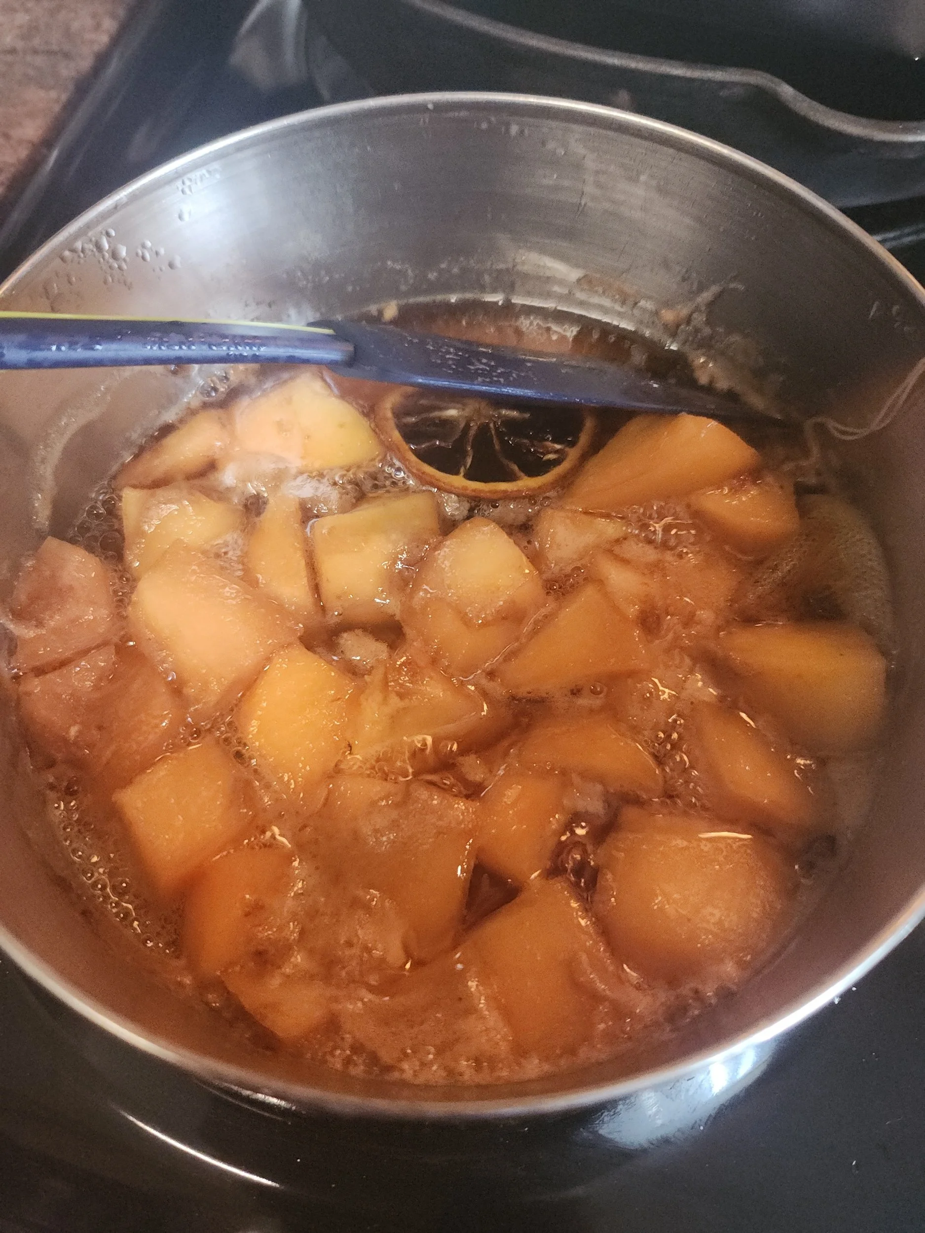 Quince cooking in pot with spices