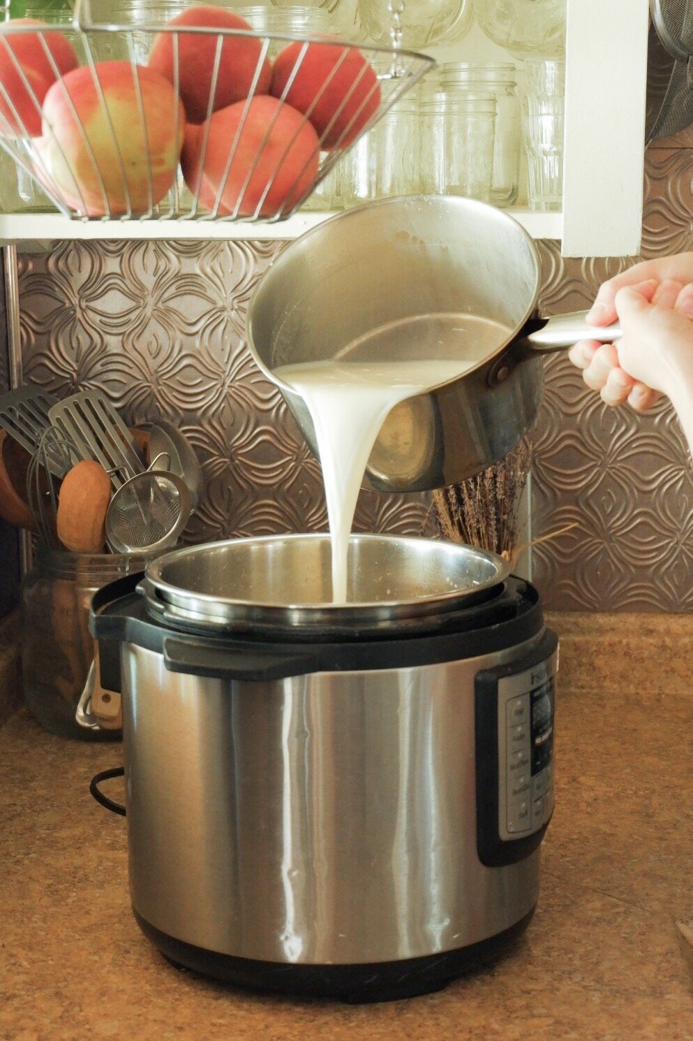 Pouring heated milk for GAPS friendly yogurt.jpg