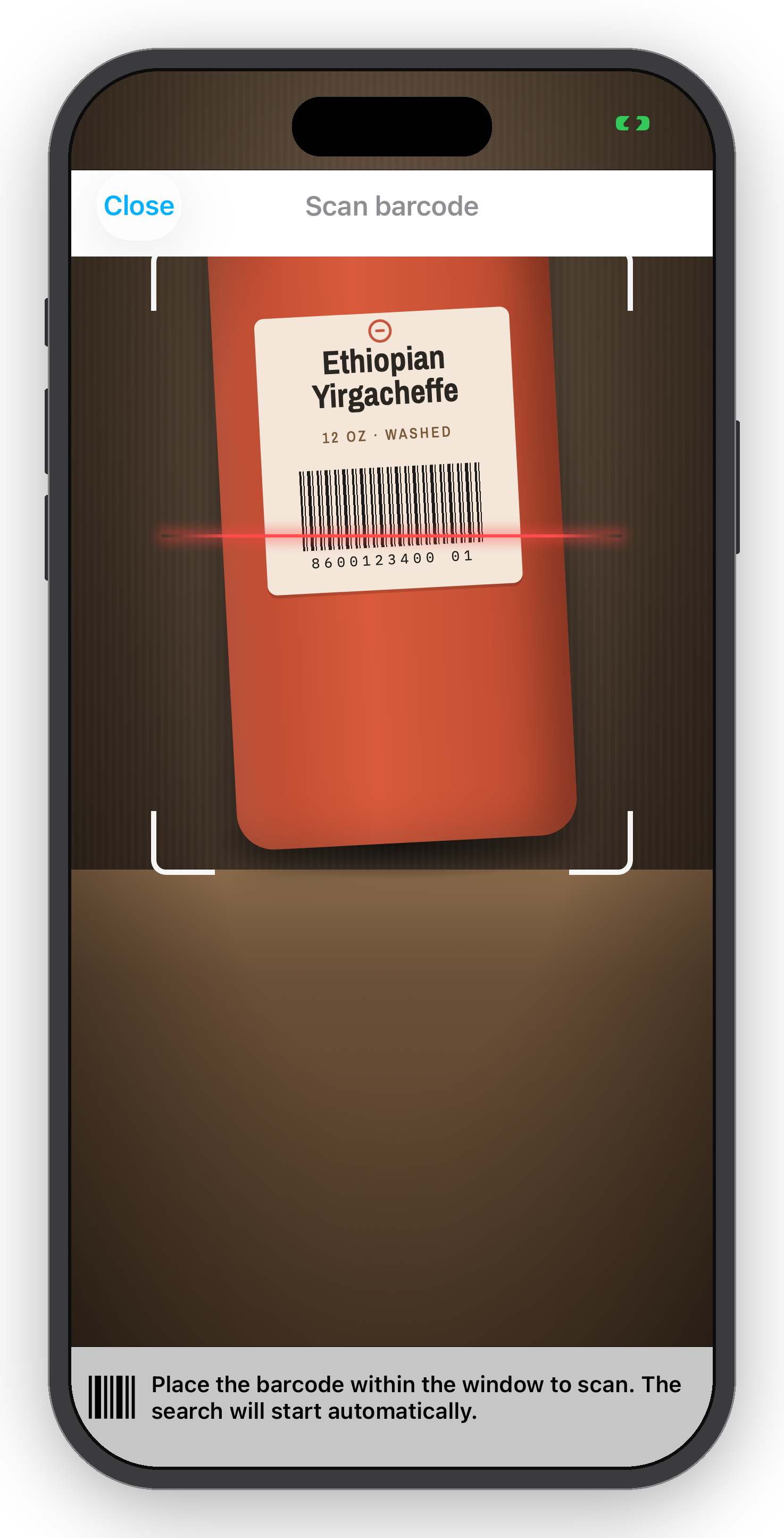 A smartphone screen displaying a barcode scanning app focused on a barcode label for Ethiopian Yirgacheffe coffee. The app instructions at the bottom read: "Place the barcode within the window to scan. The search will start automatically."