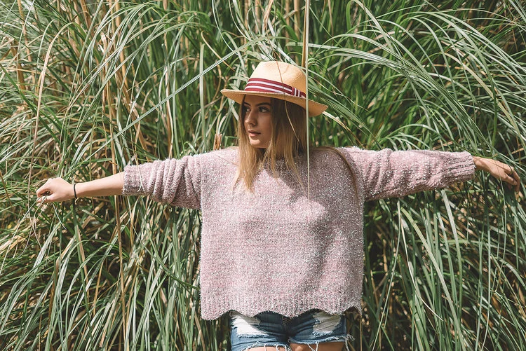 Woman wearing long brim beige summer toquilla straw hat