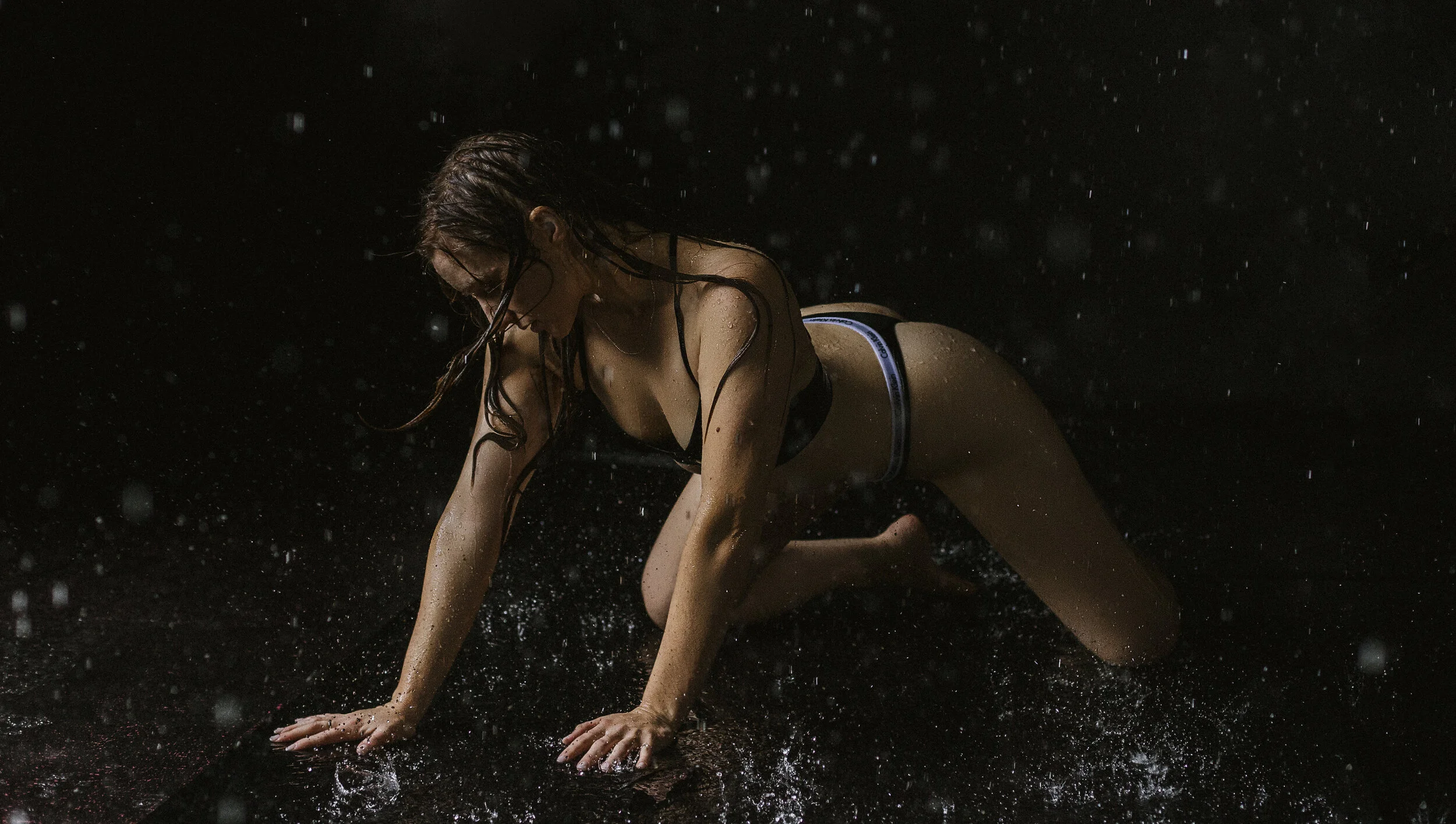 Southern California Boudoir Photography Of A Woman Crawling While Water Is Coming Down On Her Using Natural Light
