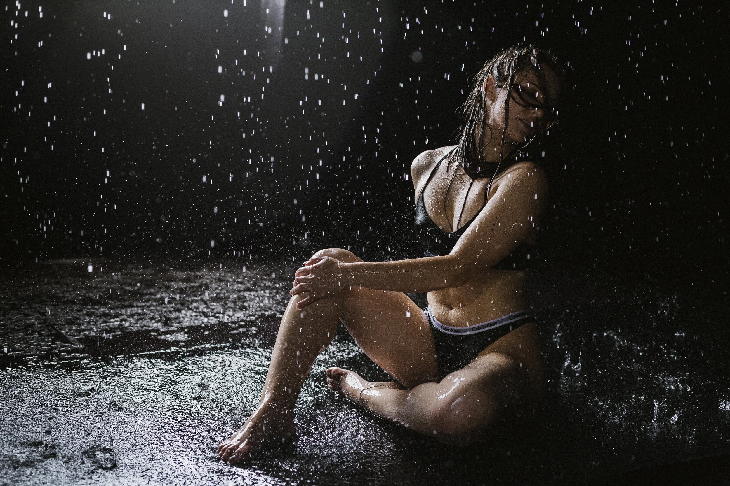 Southern California Boudoir Photography Of A Woman Sitting While Water Is Coming Down On Her Using Natural Light