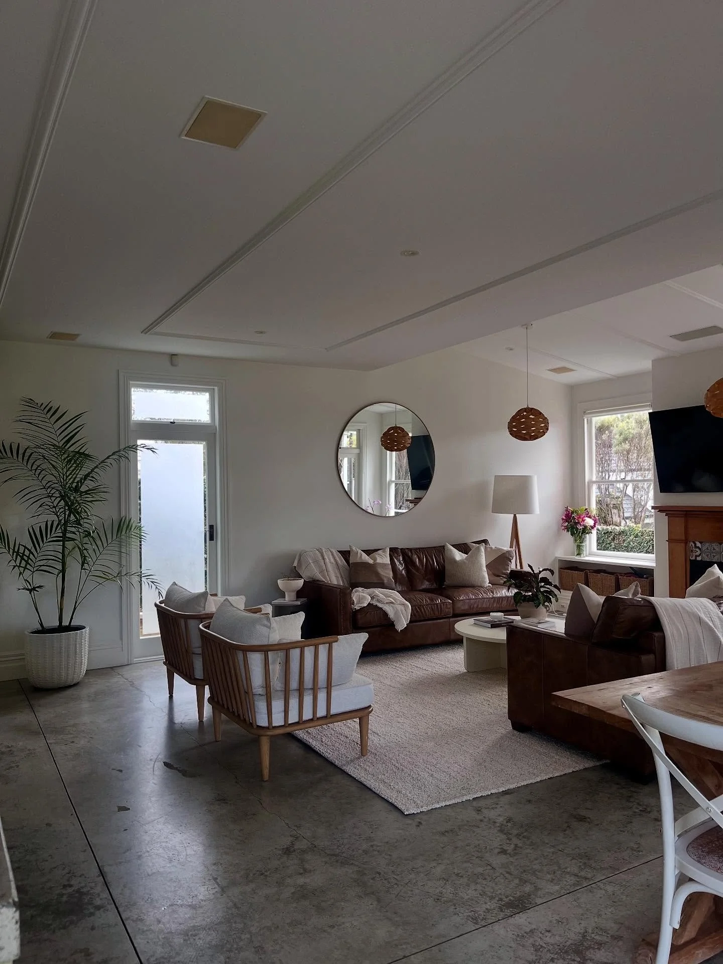 To elevate this beautiful room, I identified two key areas for improvement to achieve a greater sense of space and flow:

1. Swapping the couches to face each other, leveraging the room's natural symmetry. This enabled two chairs to be placed further