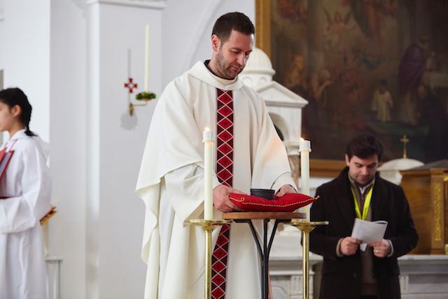 Father Gianni collecting the reliquary for insertion in the altar