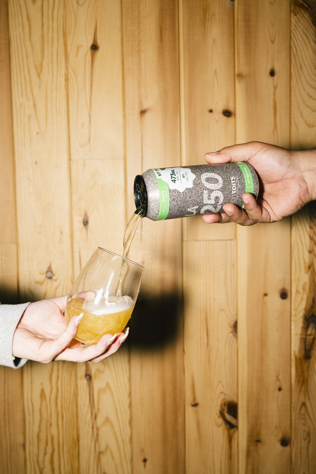 Une personne verse une boisson dans un verre à partir d'une canette
