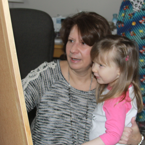 Sherry interacting with a young child during an in-home speech therapy session.