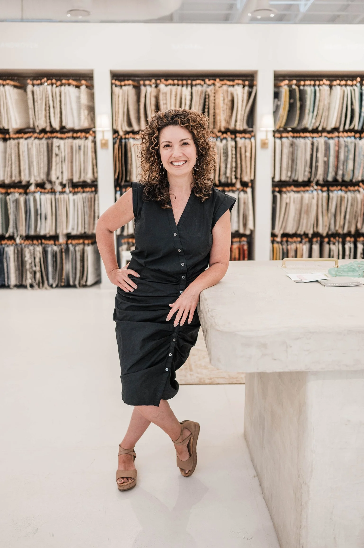 Betsy Manley in an interior design showroom surrounded by fabric samples while selecting materials for a Lake Allatoona home renovation.