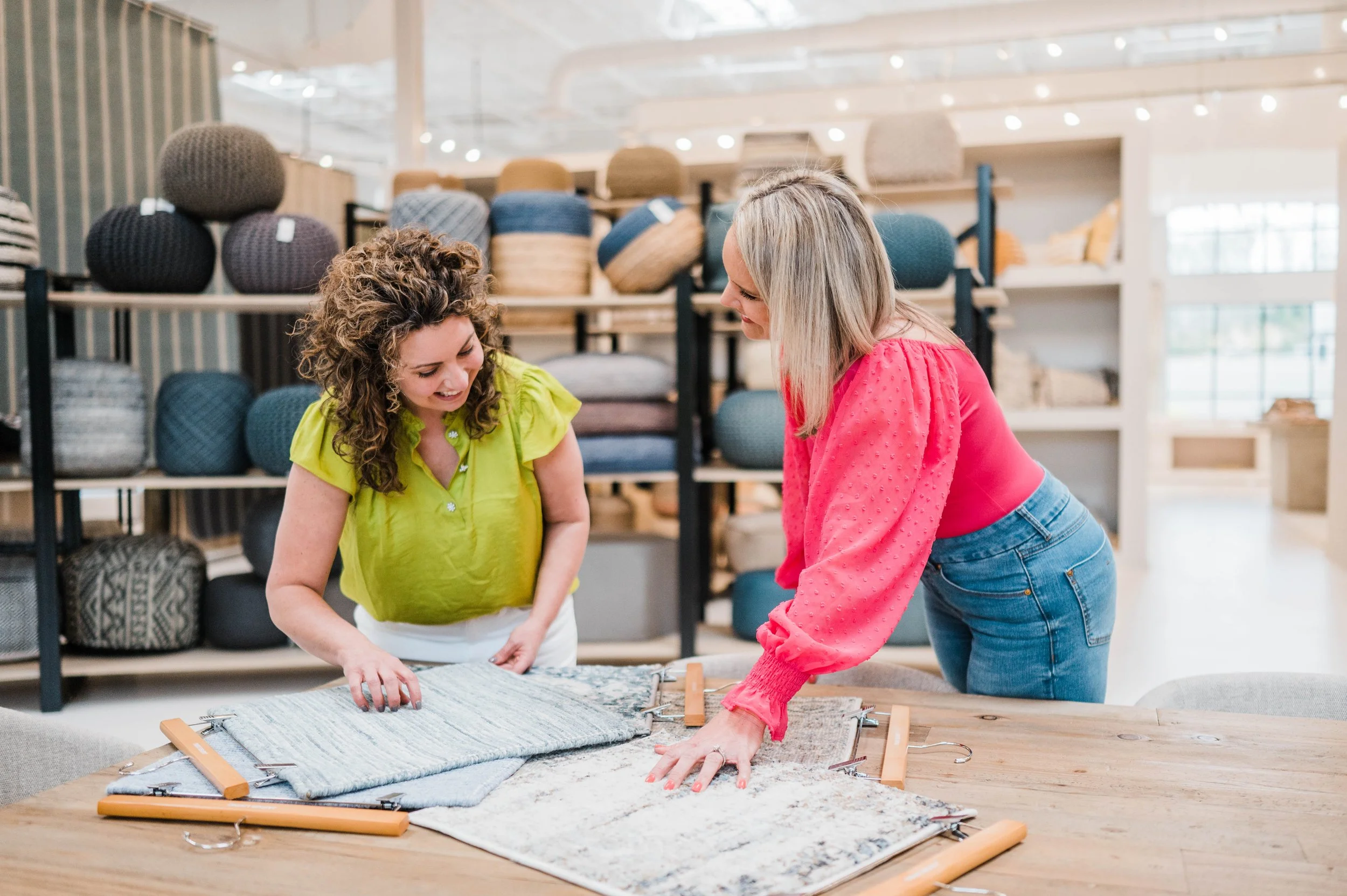 Betsy Manley and her design team selecting rug and textile samples for a luxury interior design and home renovation project.