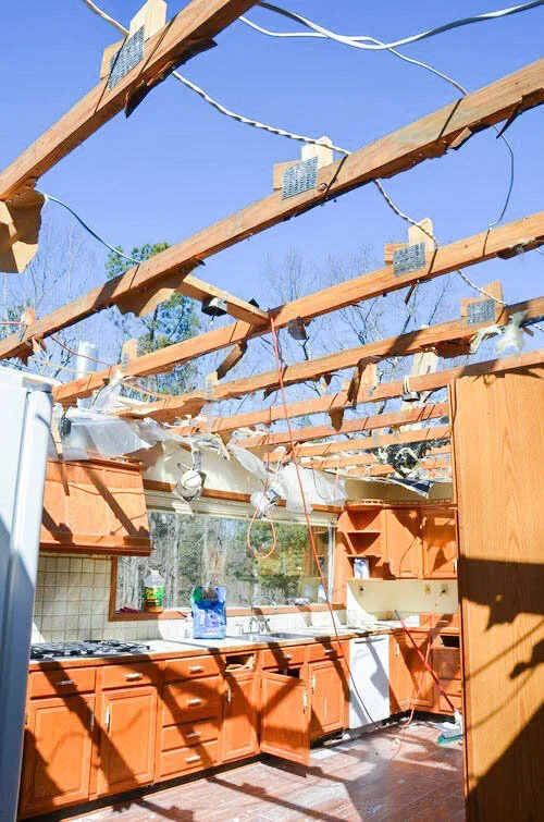 Lake Allatoona kitchen renovation in progress, showing exposed roof framing and cabinetry during a major home remodel.