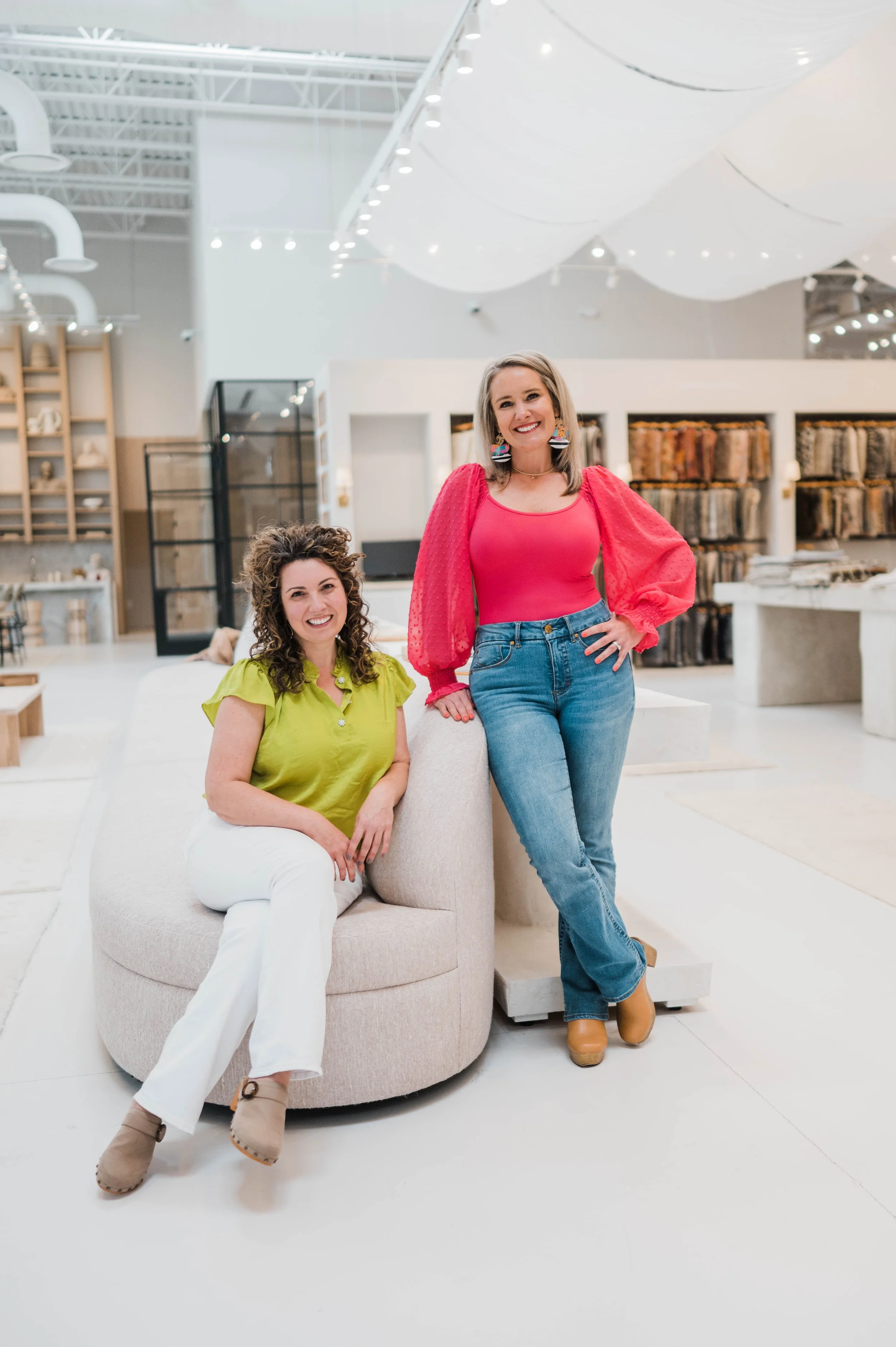 Betsy Manley and her design team in a luxury interior design showroom, helping clients create elevated, personalized homes through thoughtful renovation and design.