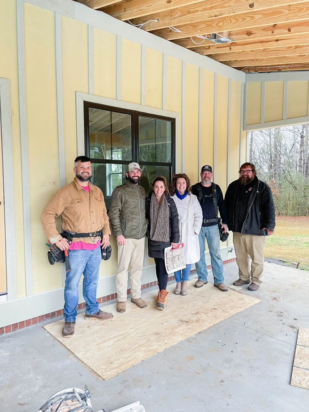 Betsy Manley with a renovation team on-site during a custom home construction and remodeling project.