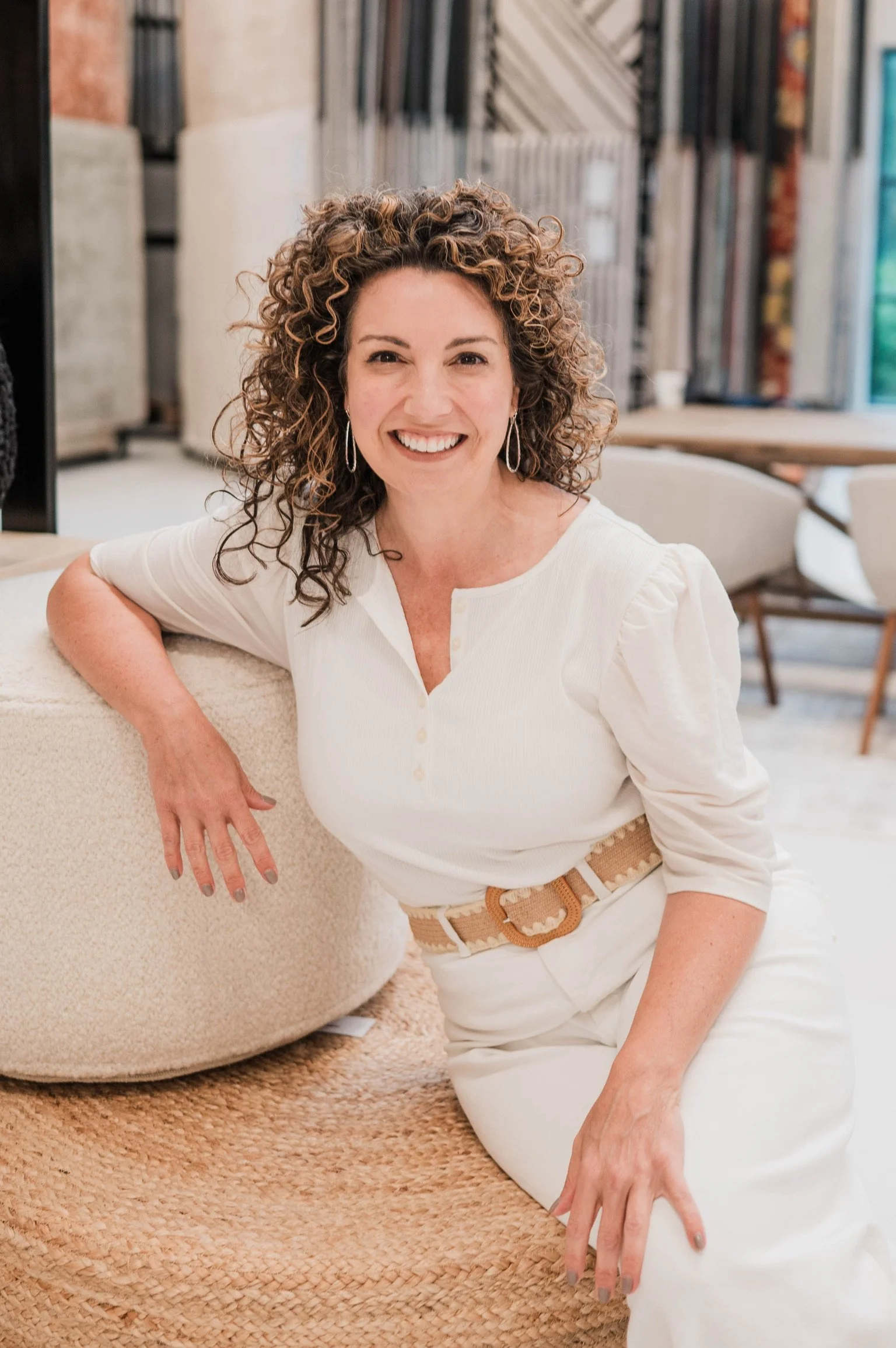 Betsy Manley, Lake Allatoona interior designer and home renovator, smiling in a bright neutral interior.
