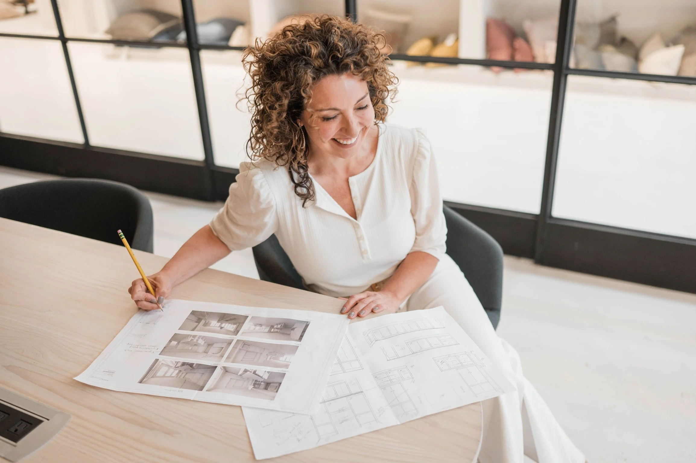 Betsy Manley reviewing renovation plans and design drawings for a Lake Allatoona home remodeling project.