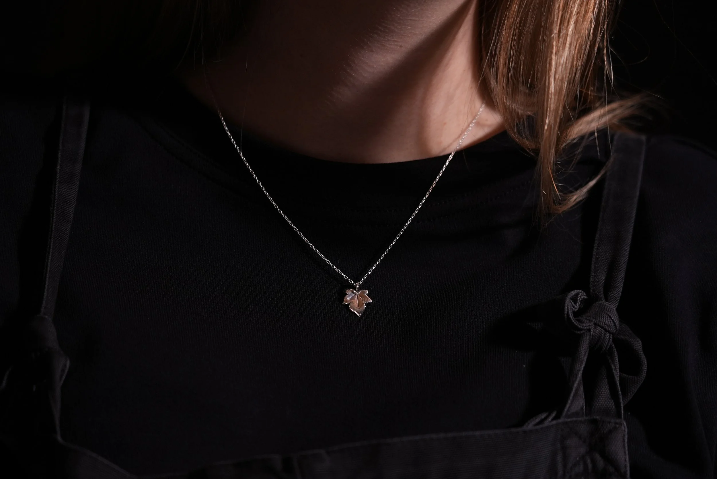 Sterling silver ivy leaf necklace worn on a fine trace chain.