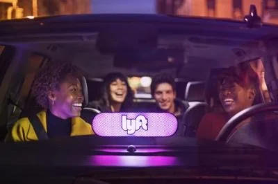 Lyft branded image of four people in a car