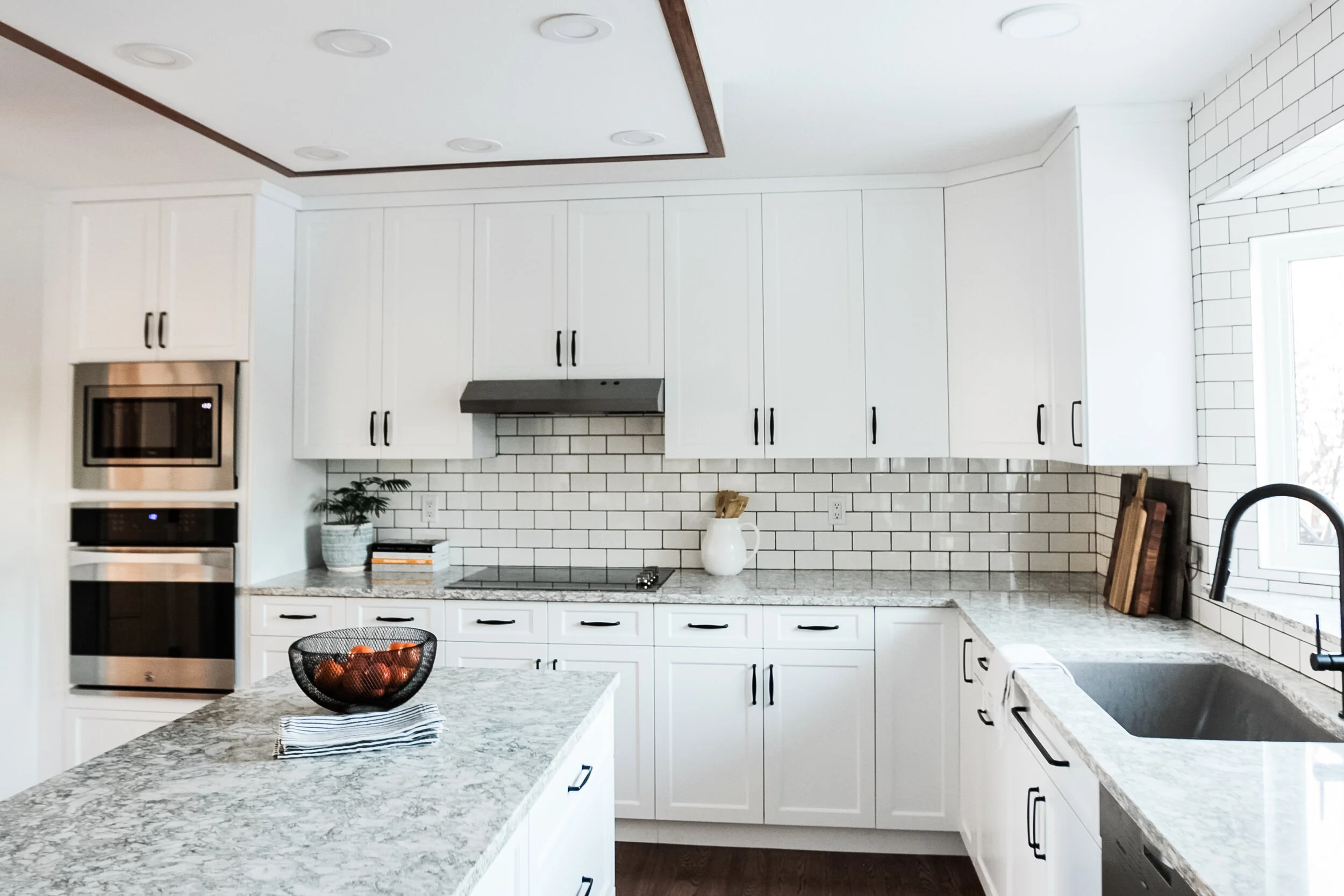 The “No longer peach abode” is a well loved house from the 1990s. The thing with the 90s, is peach was a big deal. Thankfully, we had a large footprint to work with, so my client’s dream kitchen was possible! With beautiful counters from Allstone an…