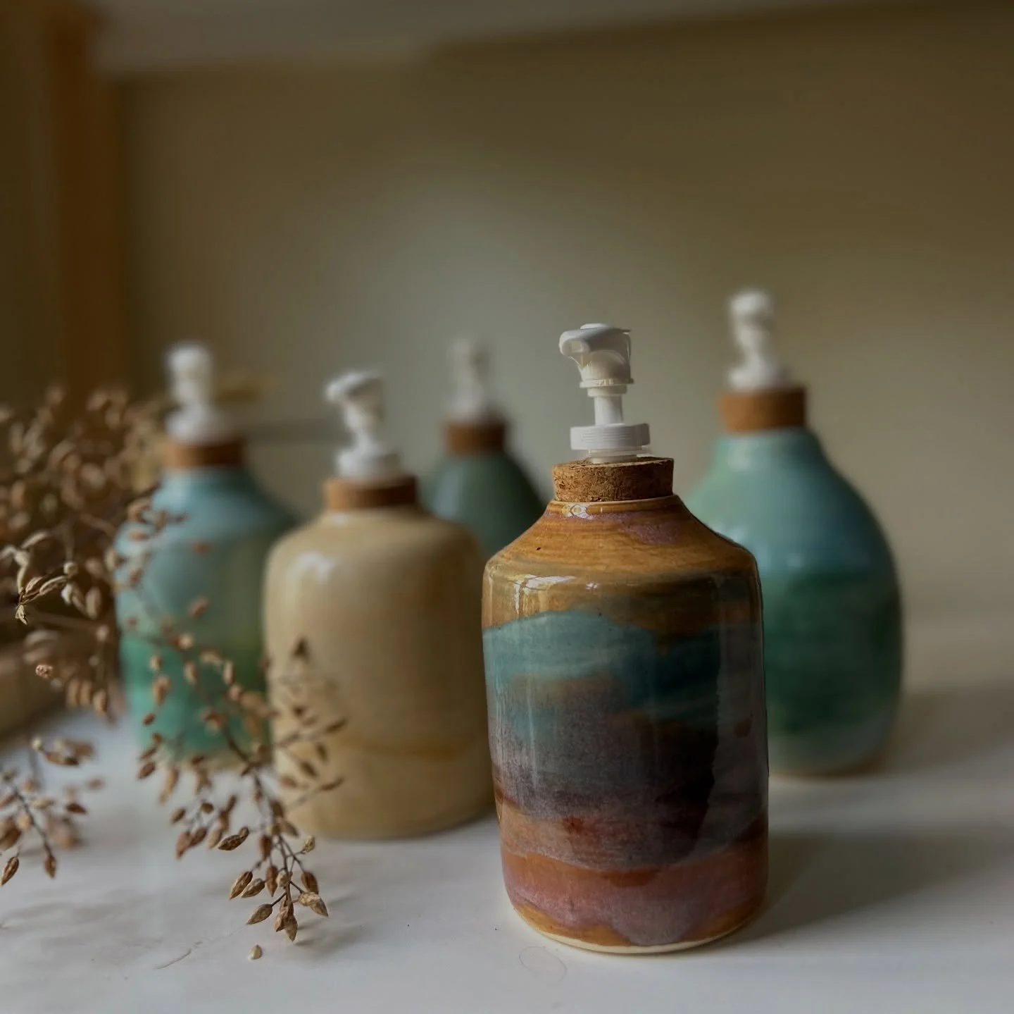 Morning light on a new crew of sweet soap dispensers that can double as small bud vases. I made these on the wheel and hand glazed them with my favorite colors. 
They will be for sale along with many other new pieces this Sunday! I will be only one o