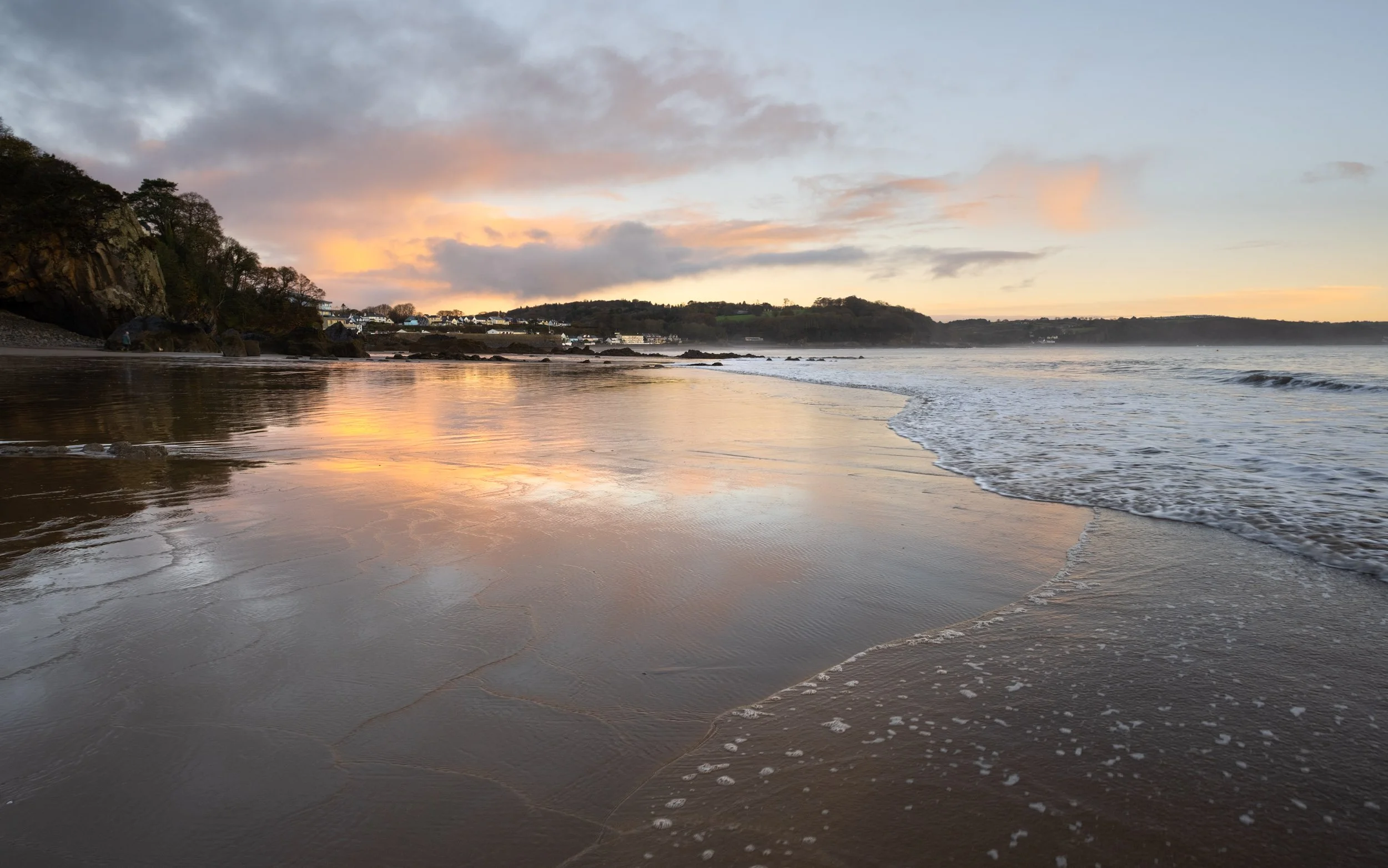 a landscape photo looking towards the coastal town of saundersfoot in pembrokeshire
