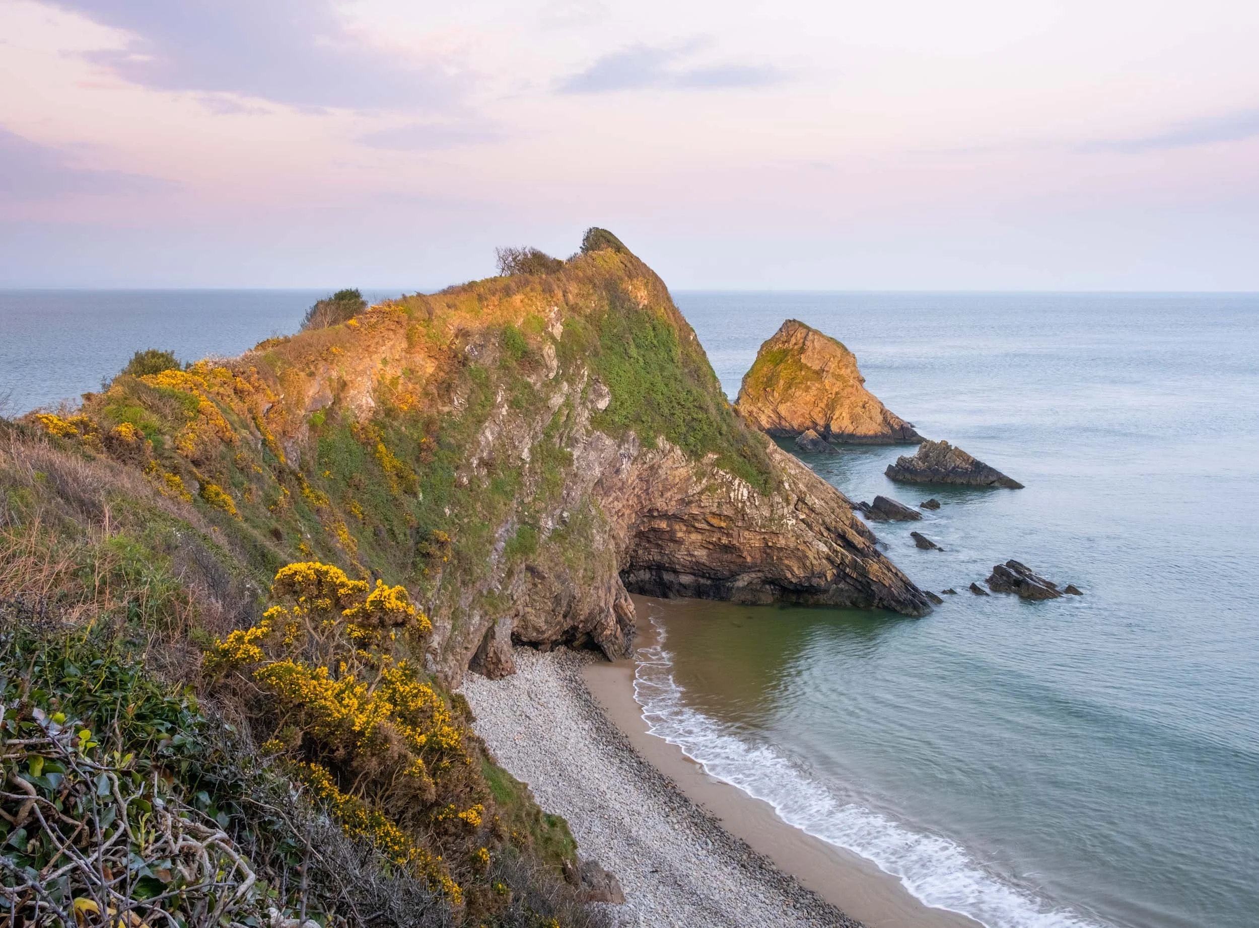 a landscape photo of monkstone point near saundersfoot in pembroekshire