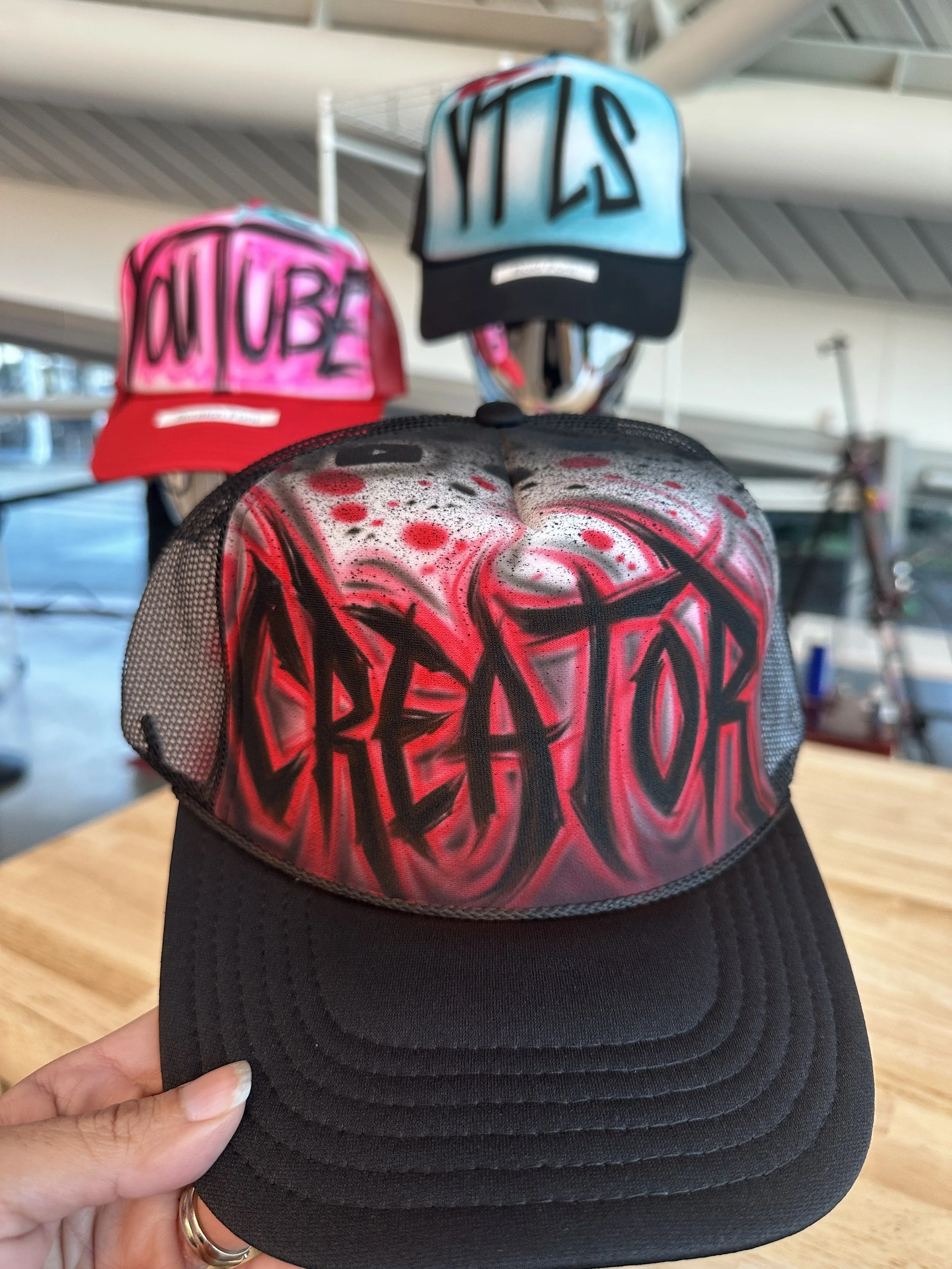 Live airbrush hat station at Las Vegas trade show booth (Copy)