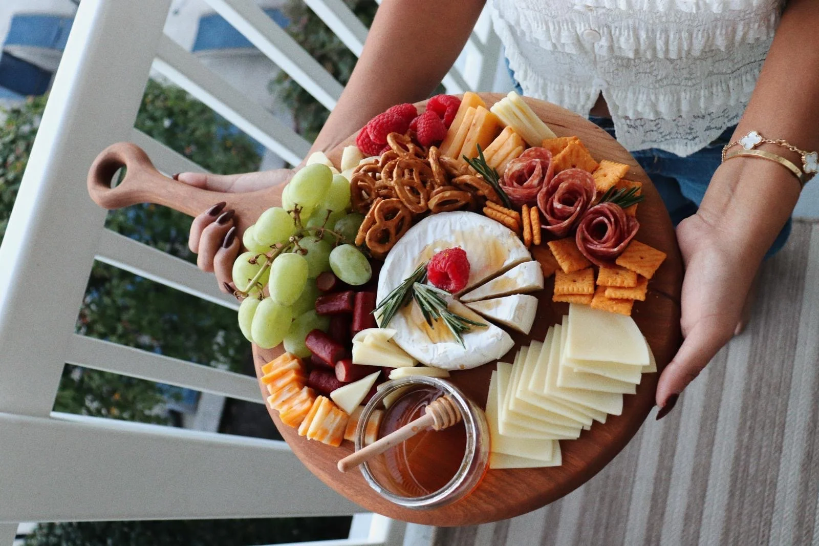 Charcuterie Board with snacks in woman's hands.JPG