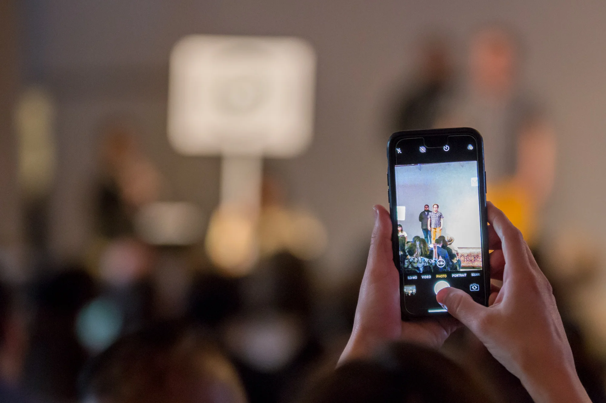 An attendee snaps a photo of John Velasquez, mayoral candidate. (Photo Credit: Joel Pena, SA Sentinel Photographer )