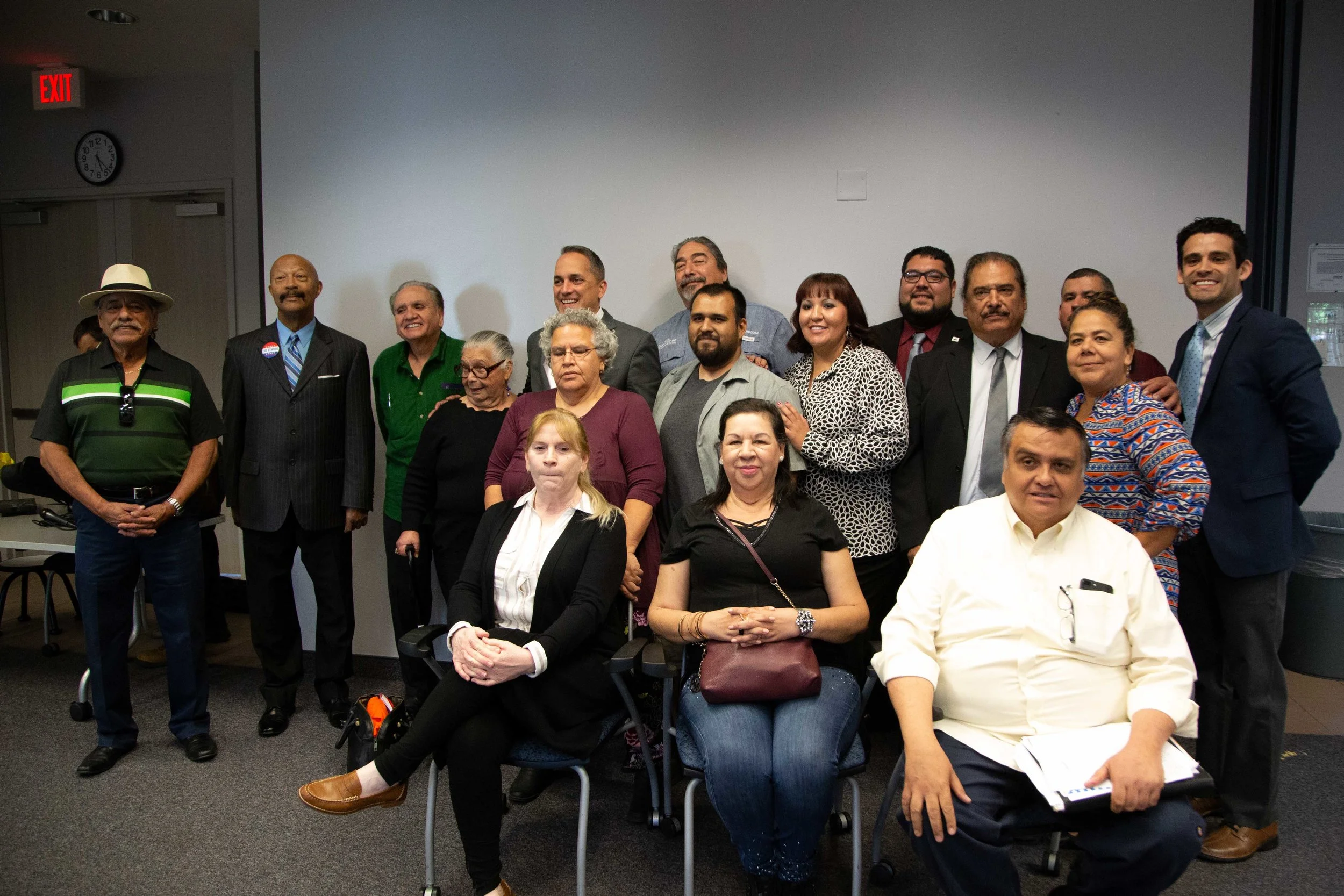 Attendees and organizers take photos with candidates at the forum. (Photo Credit: GA Media Productions )