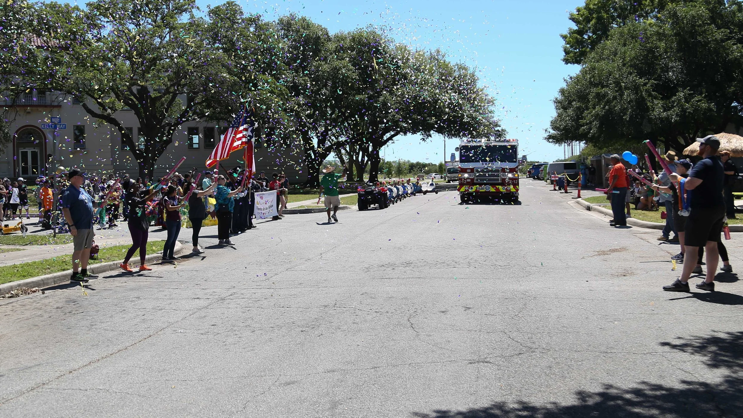 A firetruck drives through a rainfall of confetti to start the parade. (Photo by: Jonathan Guajardo - Editor, SA Sentinel)