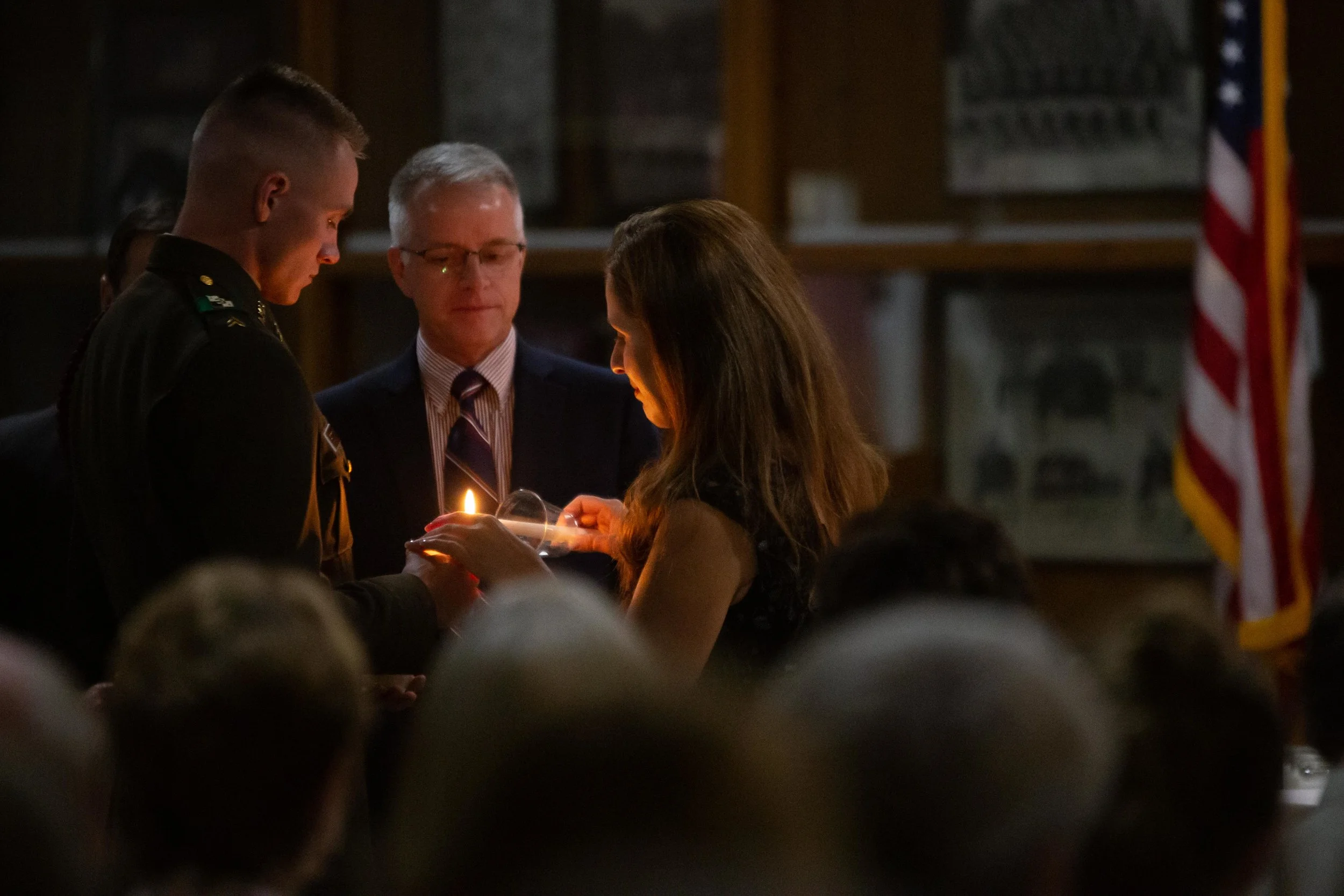 Aggies light candles in honor of the fallen at the Muster. (Photo by GA Media Media Productions .)