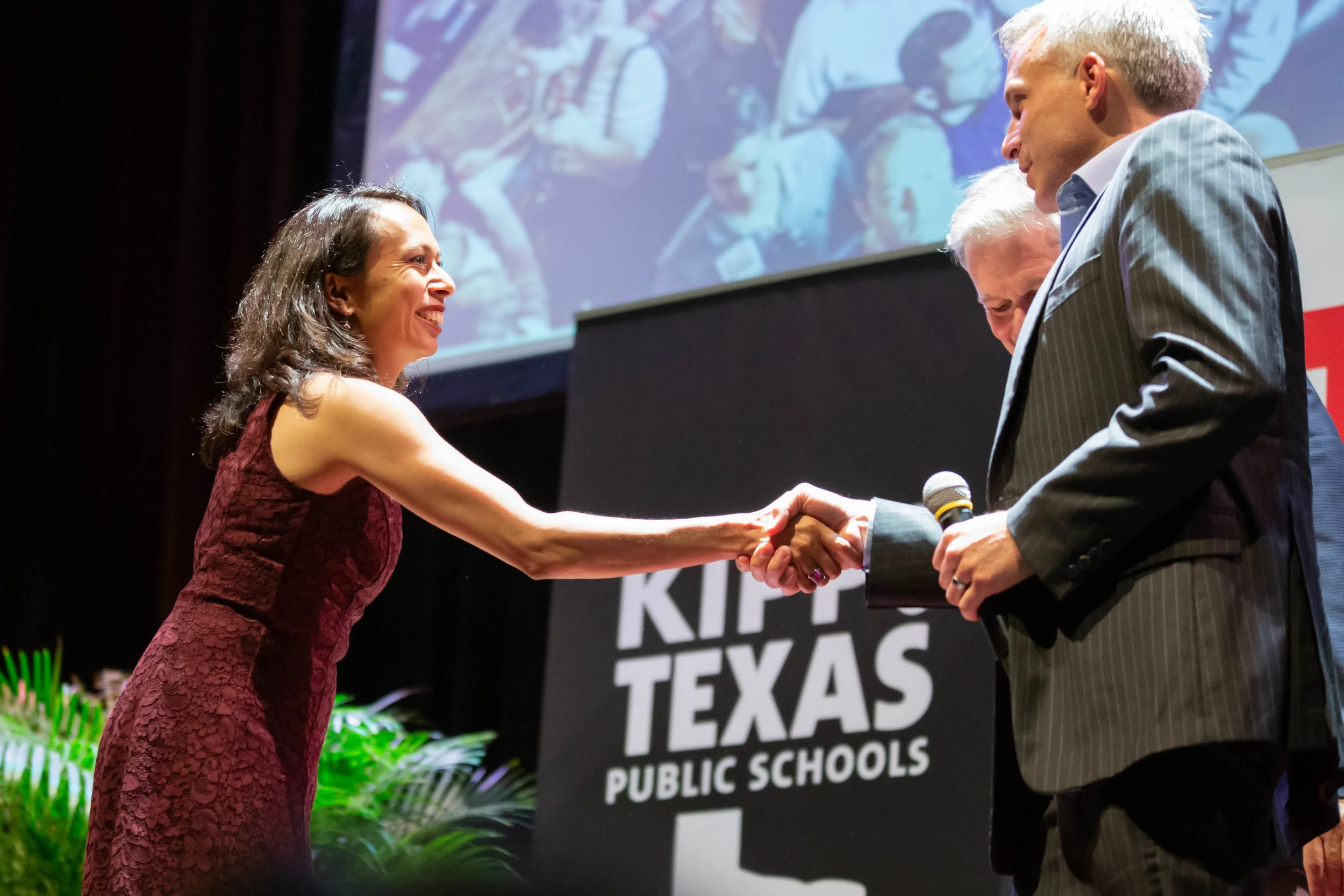 Sehba Ali and Mark Larson shake hands. (Photo by GA Media Productions .)