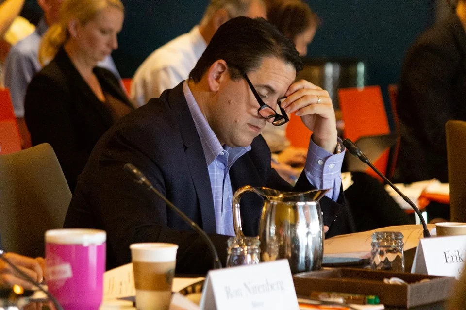 City Manager Eric Walsh reviews documents. (Photo by William Timmerman )