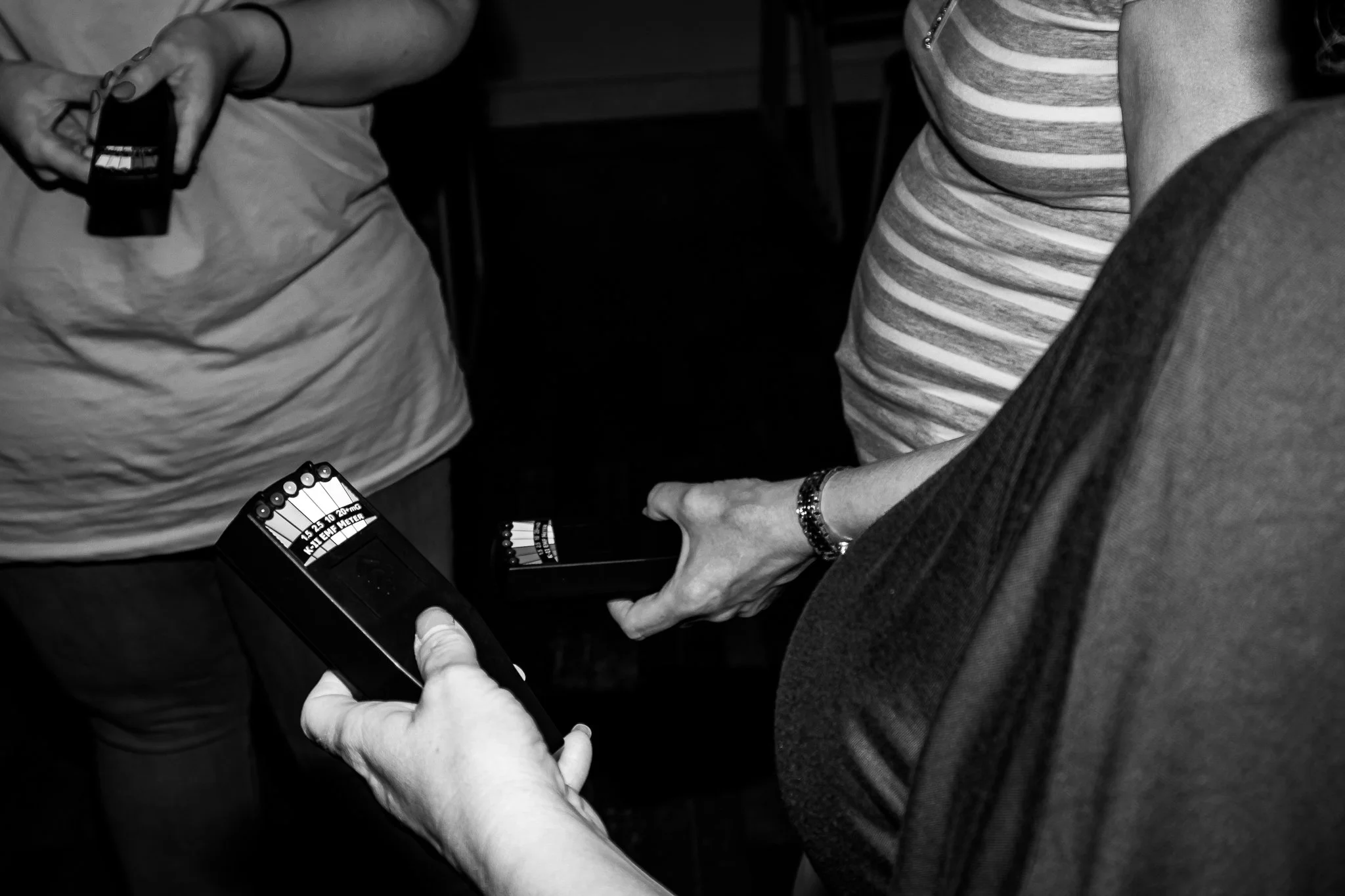 People taking batteries and a battery tester.