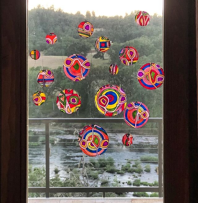 Circles with a view, #2: original drawings dipped in hot wax and cut into circles, hung from thin wire in the window. View is of the #NorthUmpquaRiver &mdash;&mdash;&mdash;&mdash;-
#installationart #worksonpaper #prismacolormarkers #markerart #encaus