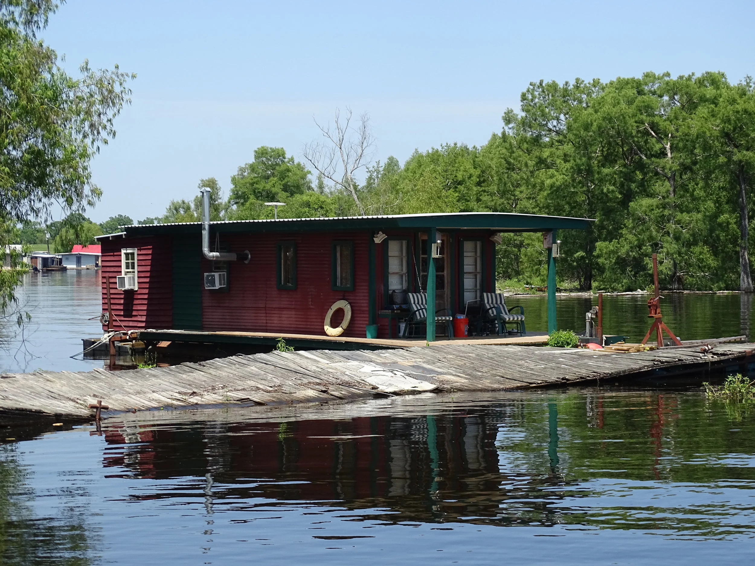  Fishing cabins cling to the shore of the swamp and pop up in clusters of trees. 