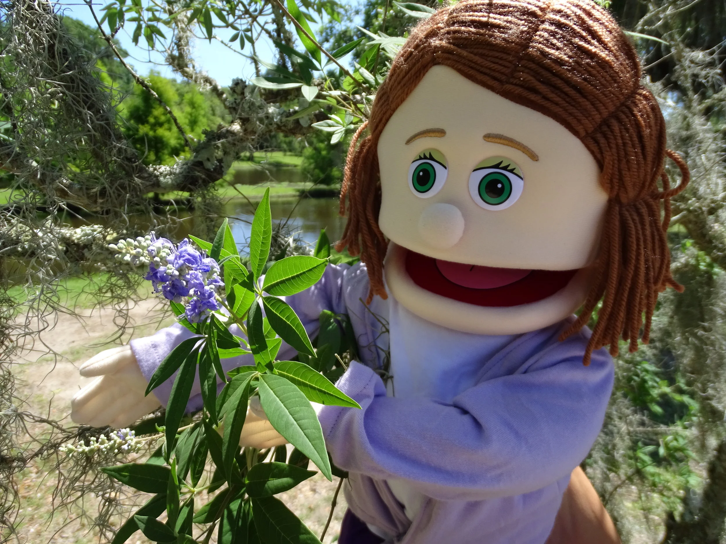  Arla enjoys looking at some of the flowers found on Avery Island. 