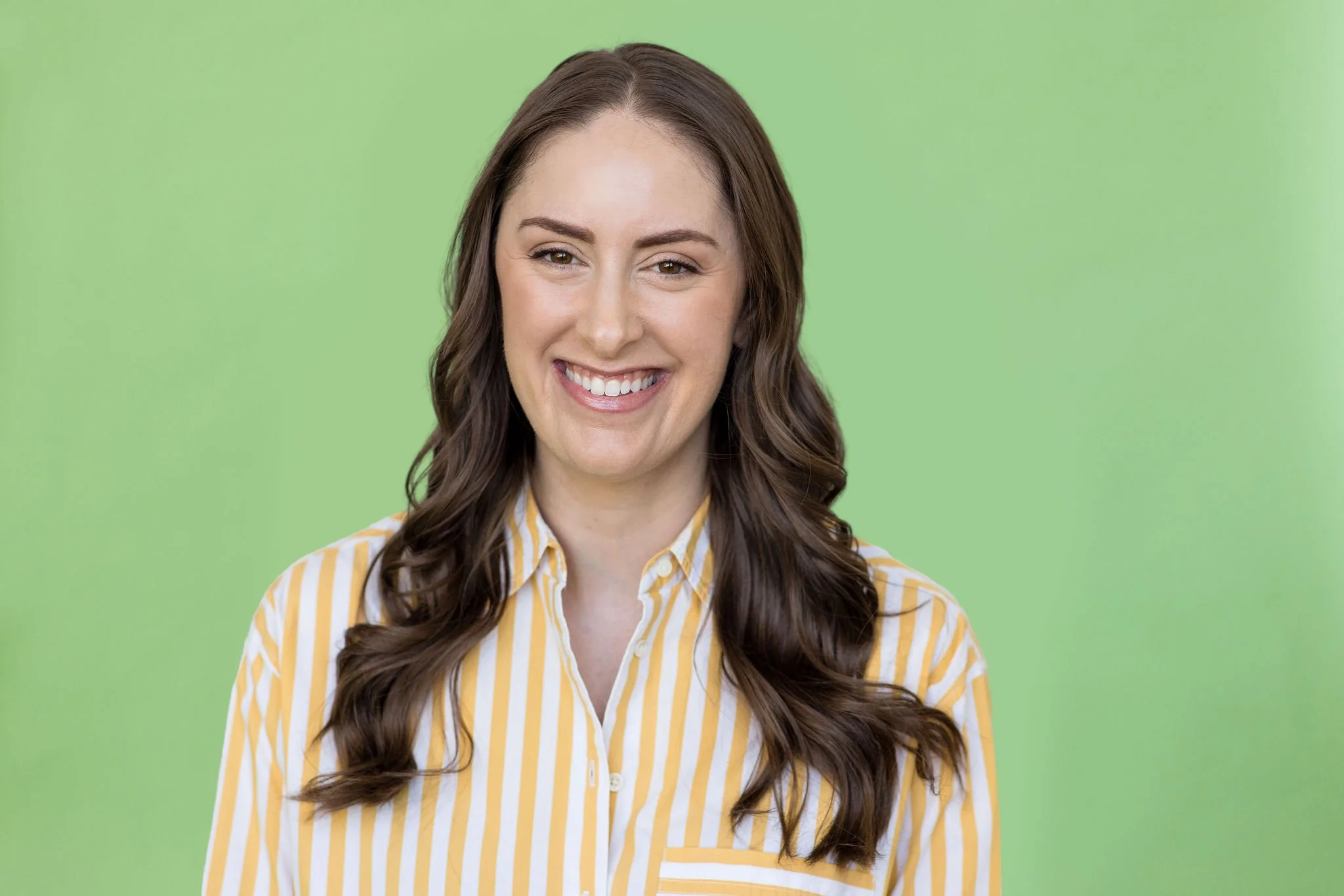 FBT dietitian in a yellow striped shirt and long brown hair smiling