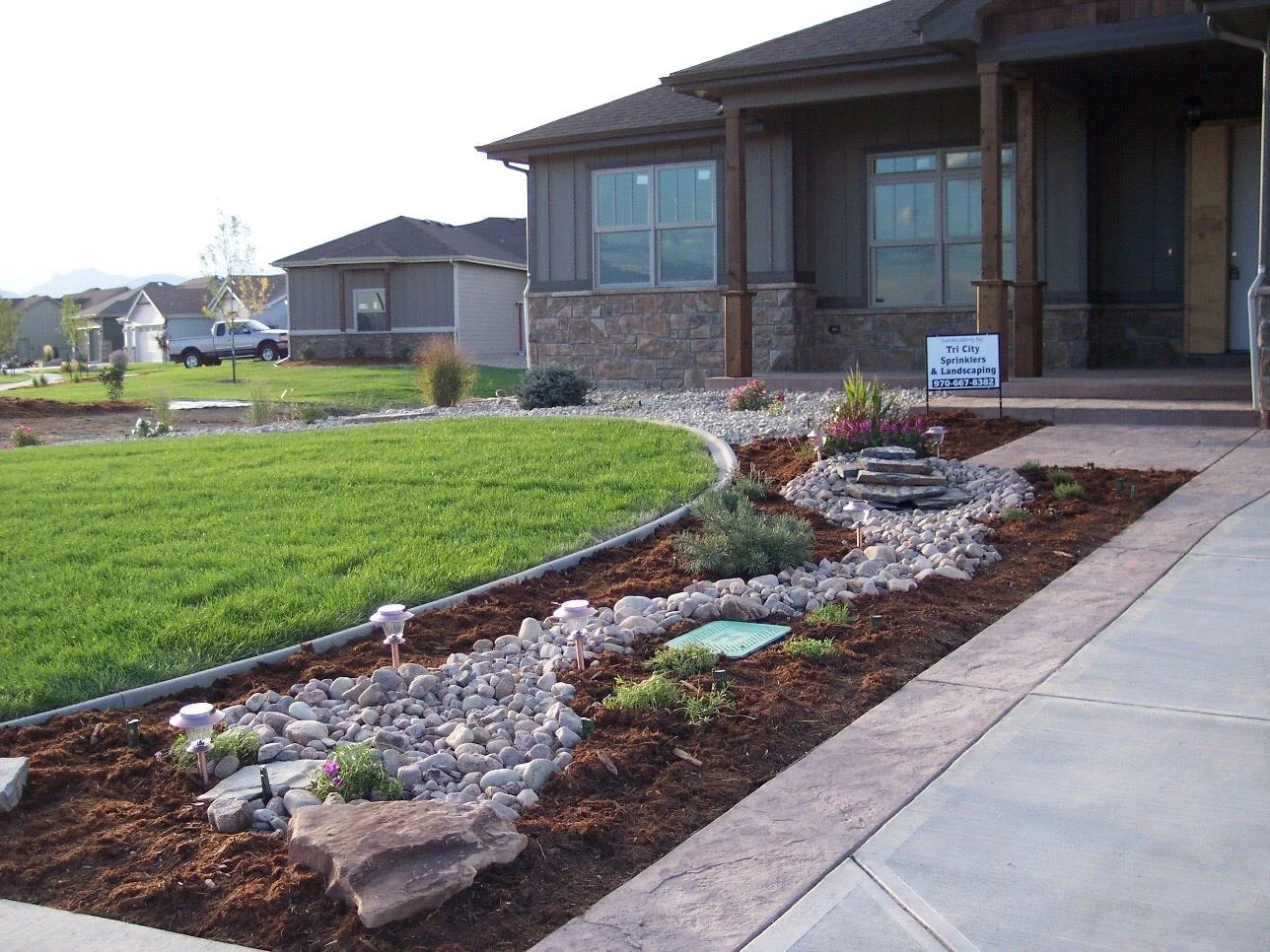 Tri City creatively designed and installed this landscape masterpiece, which won the Parade of Homes in 2014. Titus created the cobble stone stream during on-site changes to the contract during install.