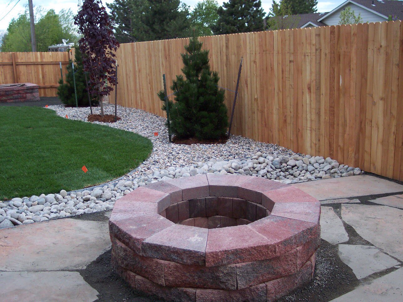 Versa Lok fire pit, fence, plantings, and rock install.