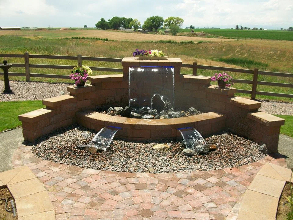 Beautiful fountain and planters created out of Versa Lok blocks and Belgard paver patio.