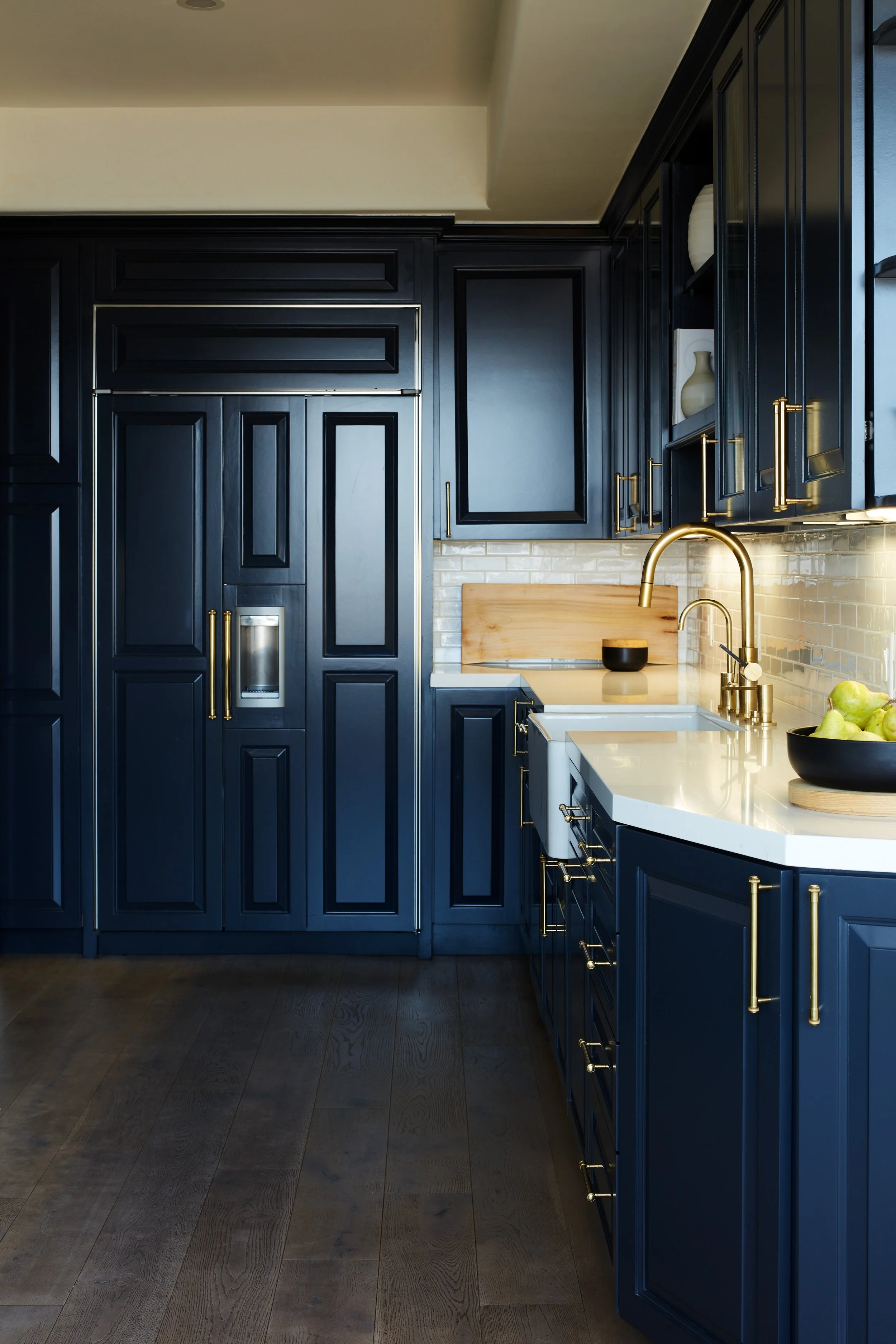 Renovated kitchen with custom cabinetry, stone countertops, and warm wood detailing in a Wilshire Corridor penthouse.