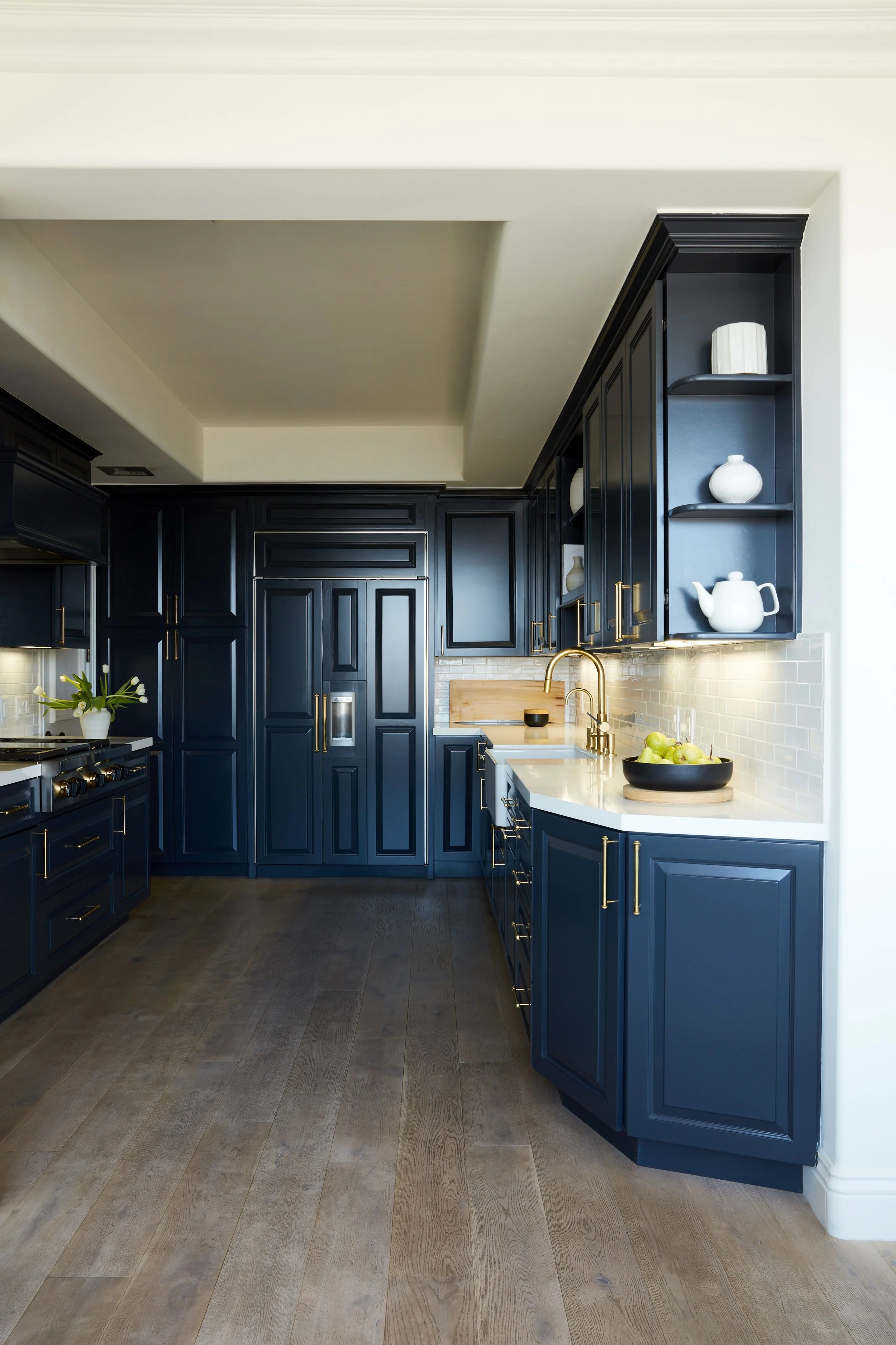 Detailed view of the remodeled penthouse kitchen with custom cabinetry and refined finishes.