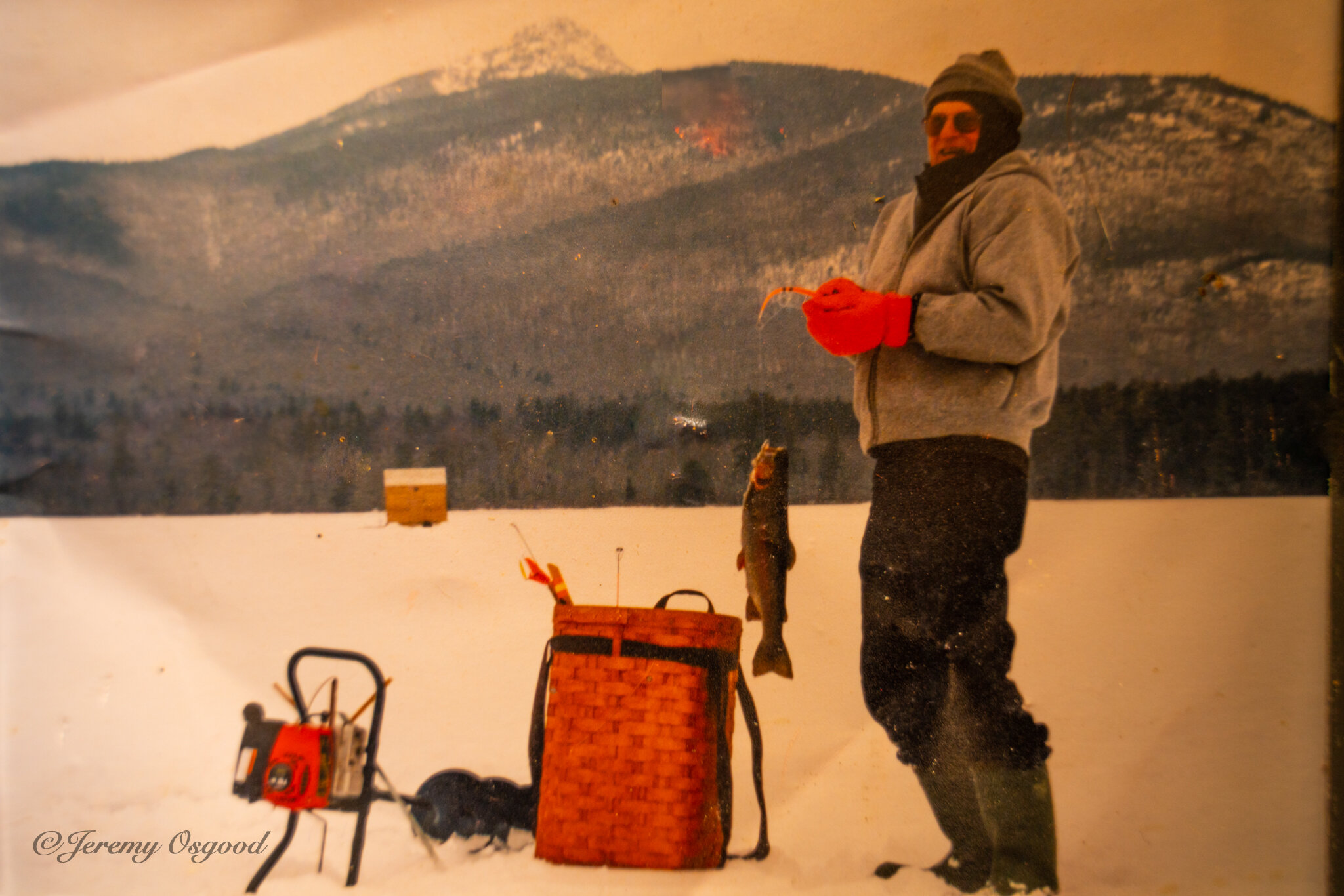 Photo of a photo taken back in the 1990’s ice fishing at Chocorua Lake. The fish house in the back was built by my brothers, Grandpa Tinker, and I, at his home in West Ossipee. He was a ridge-runner and storyteller, an inspirational force behind t…