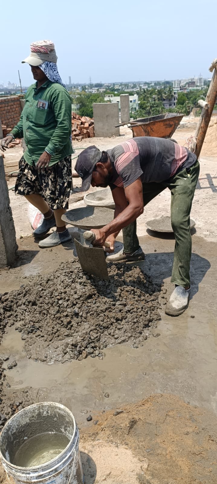 Working mixing concrete for top floor water tank.