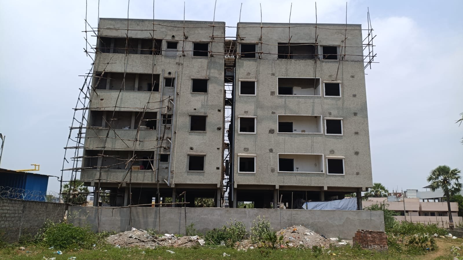 Exterior view of the twin buildings that make up the girls' home with top floor, exterior plaster completed.