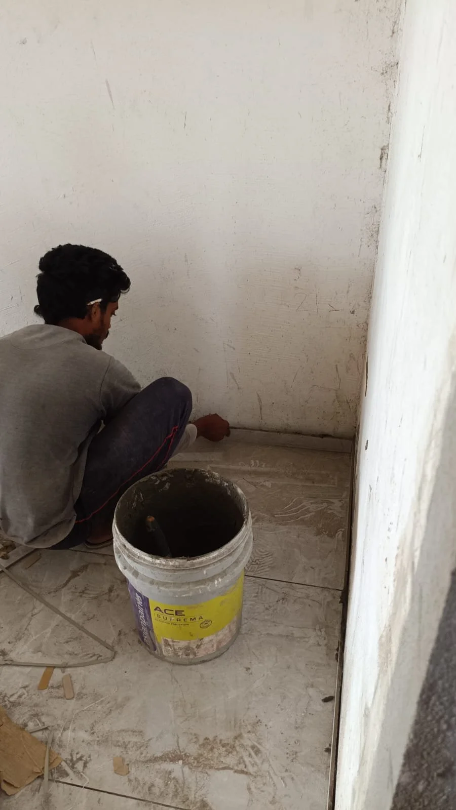Worker grouting tile.