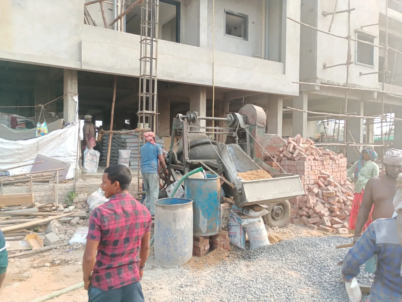 Construction team mixing concrete.