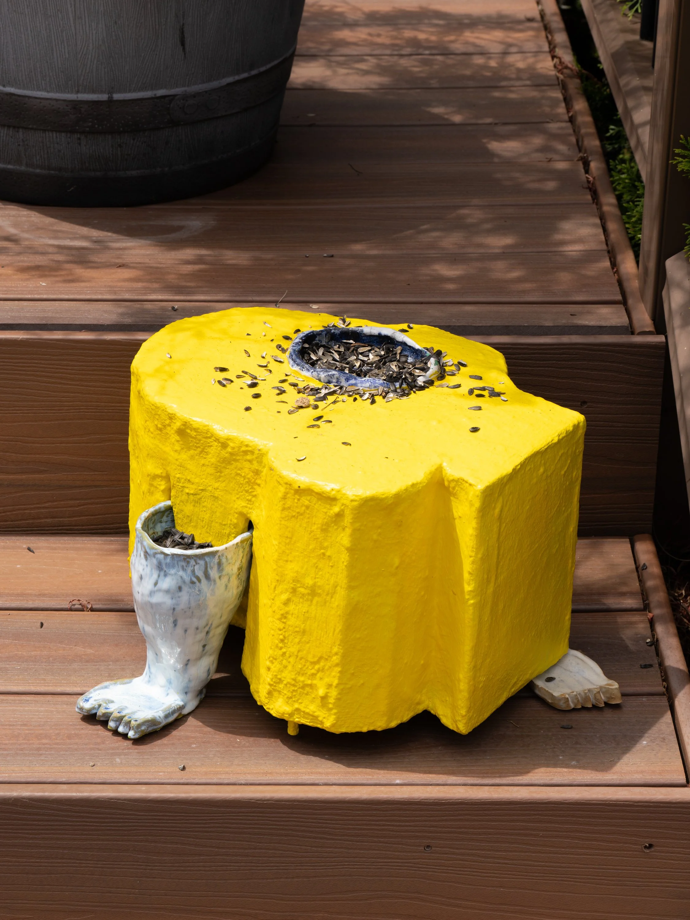 A yellow sculpture with sunflower seeds