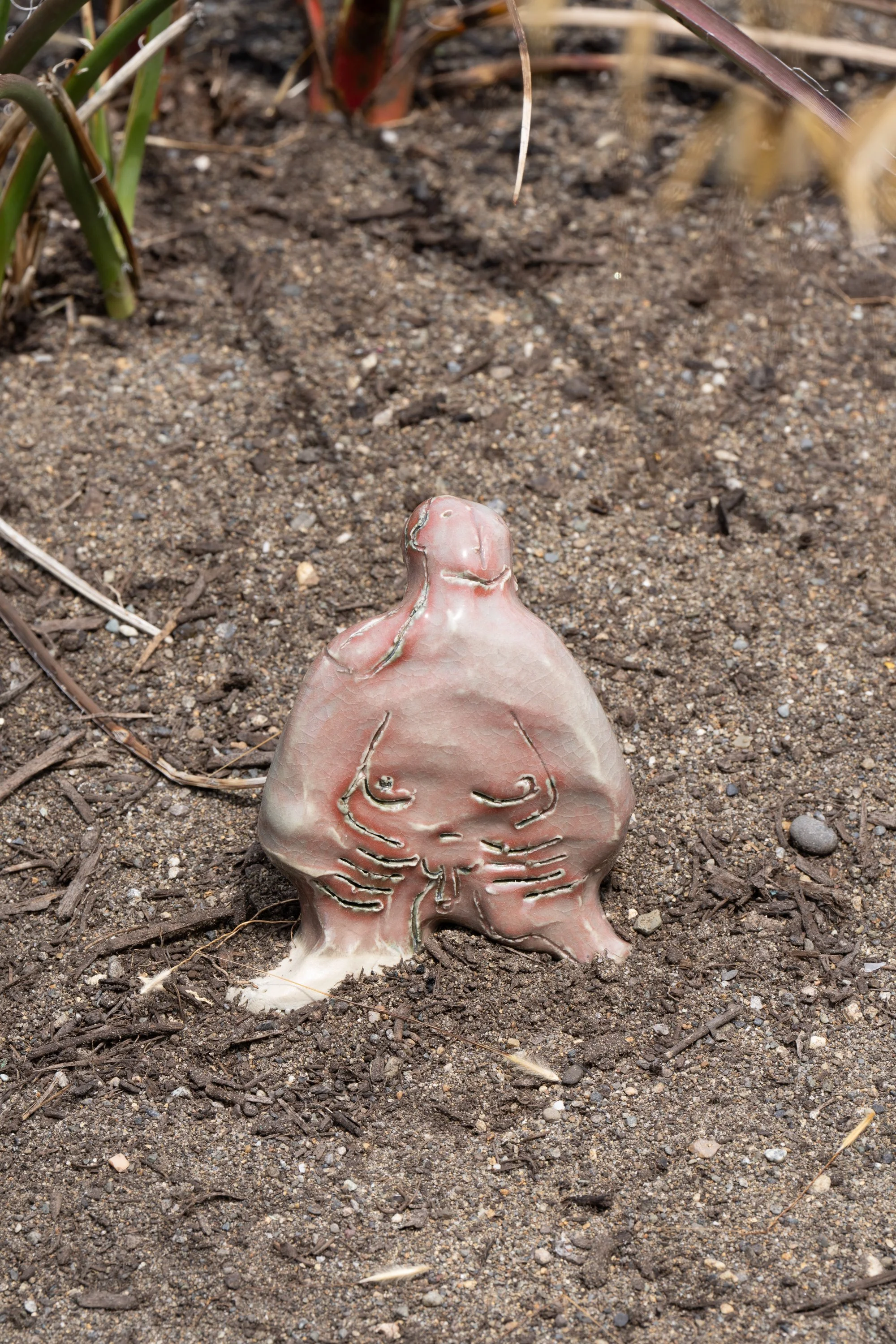 A ceramic figure on the ground.