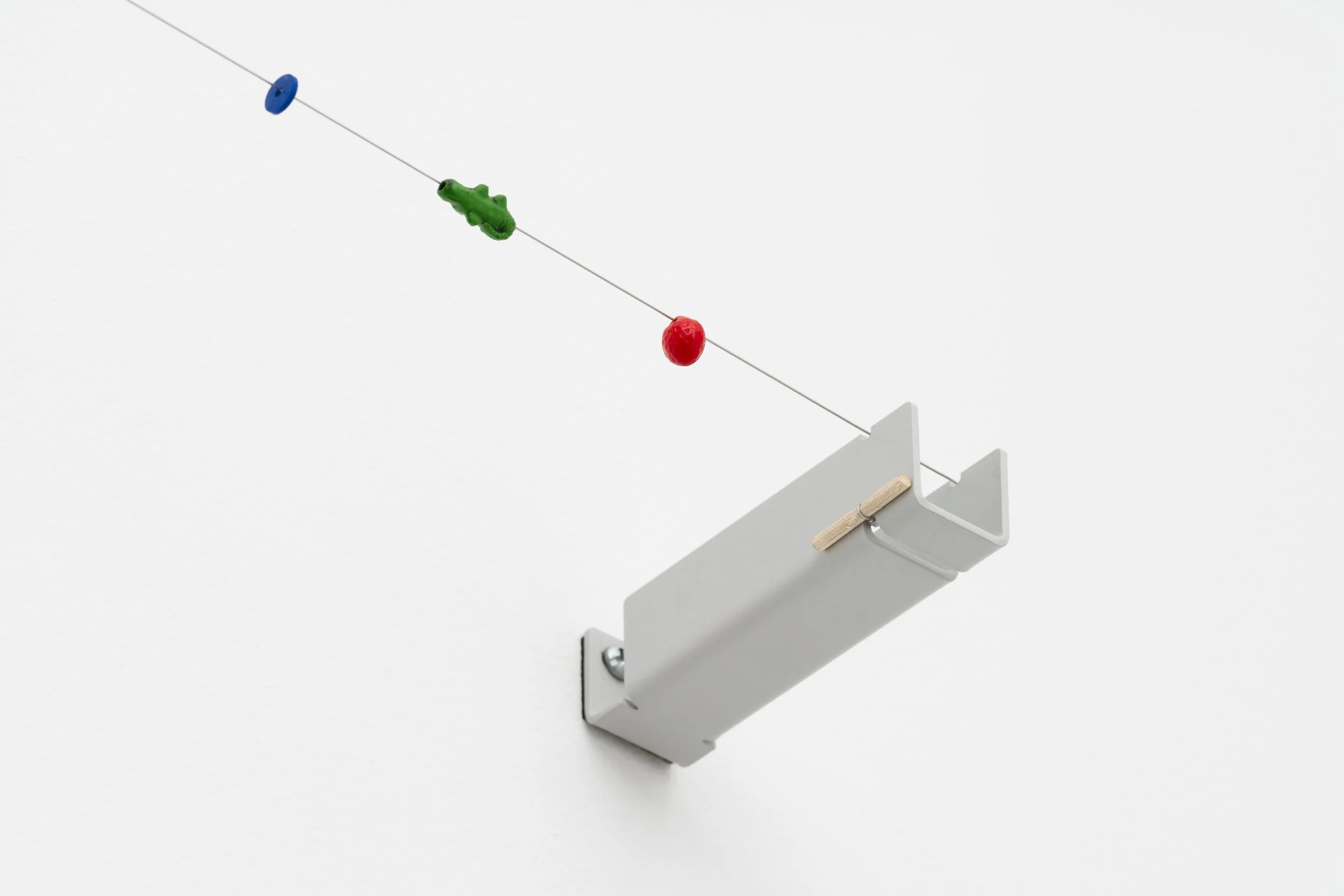 small beads on a wire held tight on a metal bracket